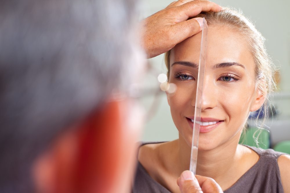Female patient model getting her face measured
