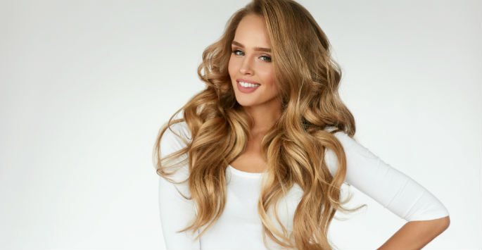 Beautiful patient model smiling with long wavy hair