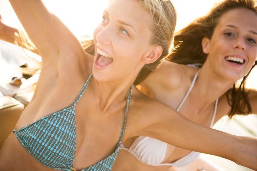 2 young girls wearing bikini and laughing, excited