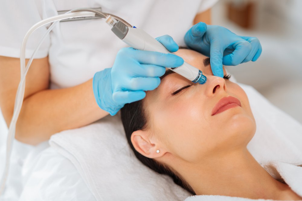 Patient getting face treatment done with a needle