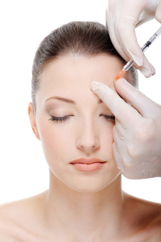 Female patient model getting injected over the brow