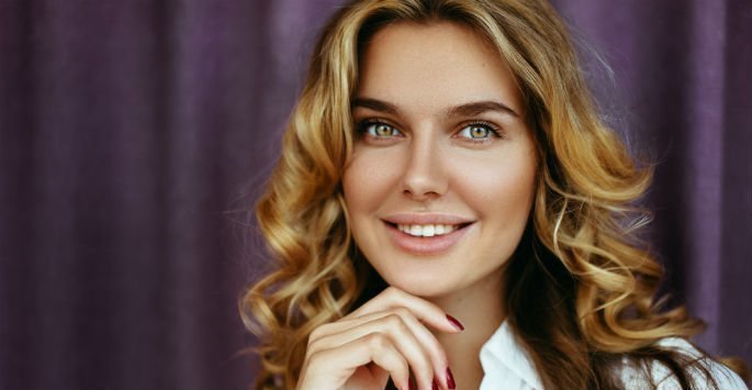Beautiful female patient model with no wrinkles, smiling