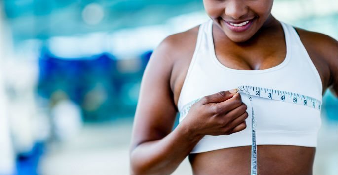 Breast Augmentation patient female model with a measuring tape over her chest